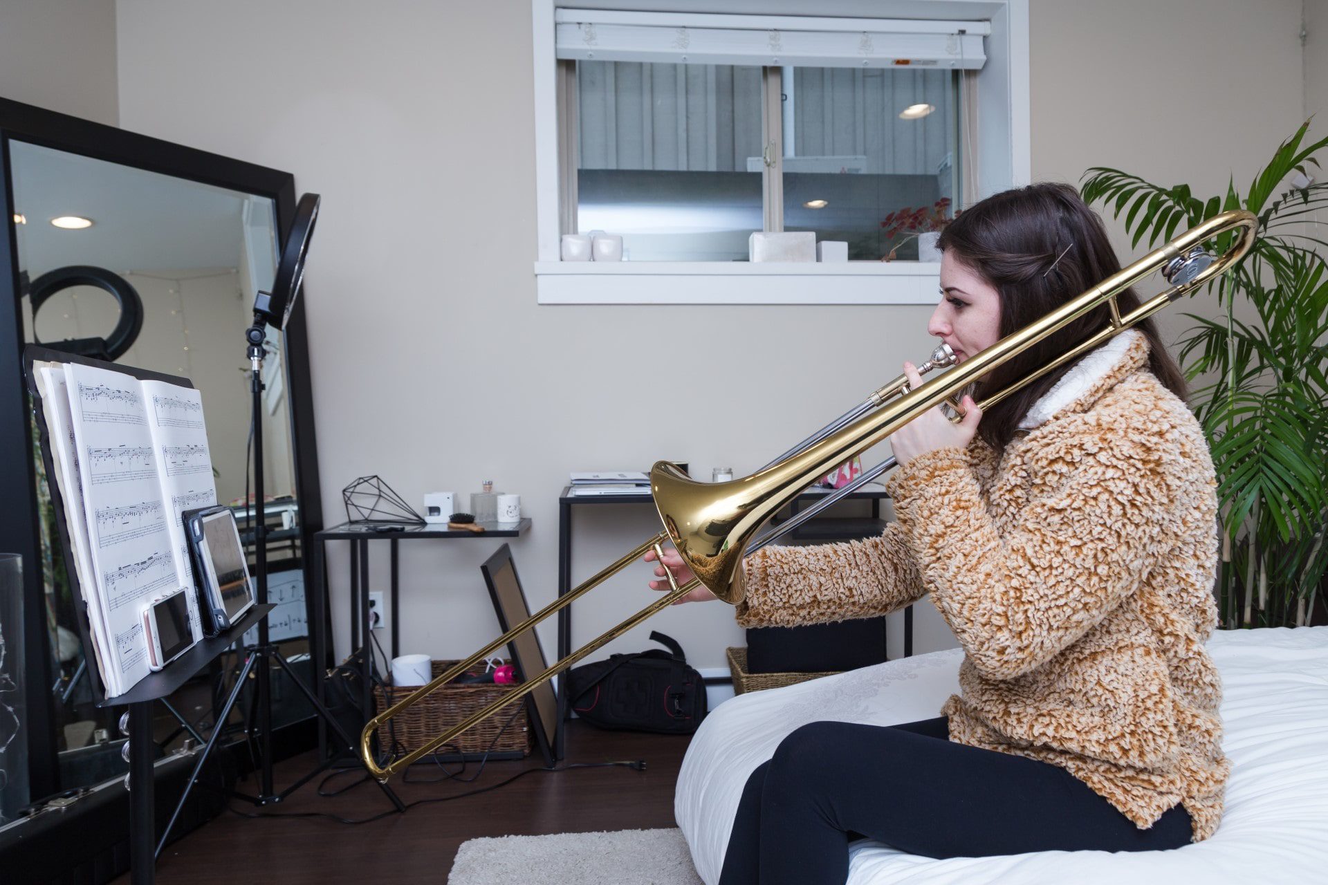 Student practicing trombone at home with Practicing Musician