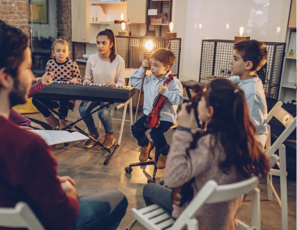 students actively participating in a hands-on, collaborative music activity during class time.group music lessons