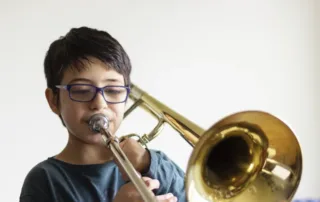 Student playing a beginner trombone