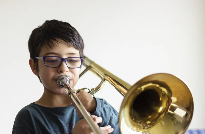 Student playing a beginner trombone